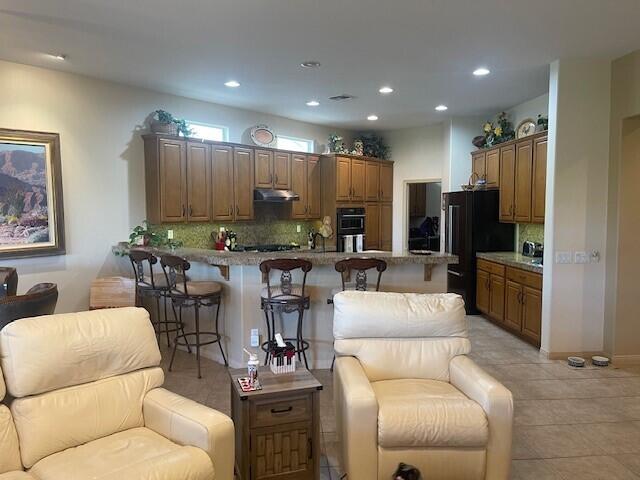 80548 Knightswood Road Indio, CA 92201 - Photo 54 of 56 Wide angle of two chairs and kitchen