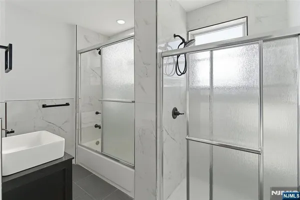 a bathroom with a shower and a sink
