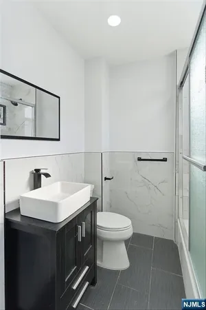 a bathroom with a sink toilet and mirror