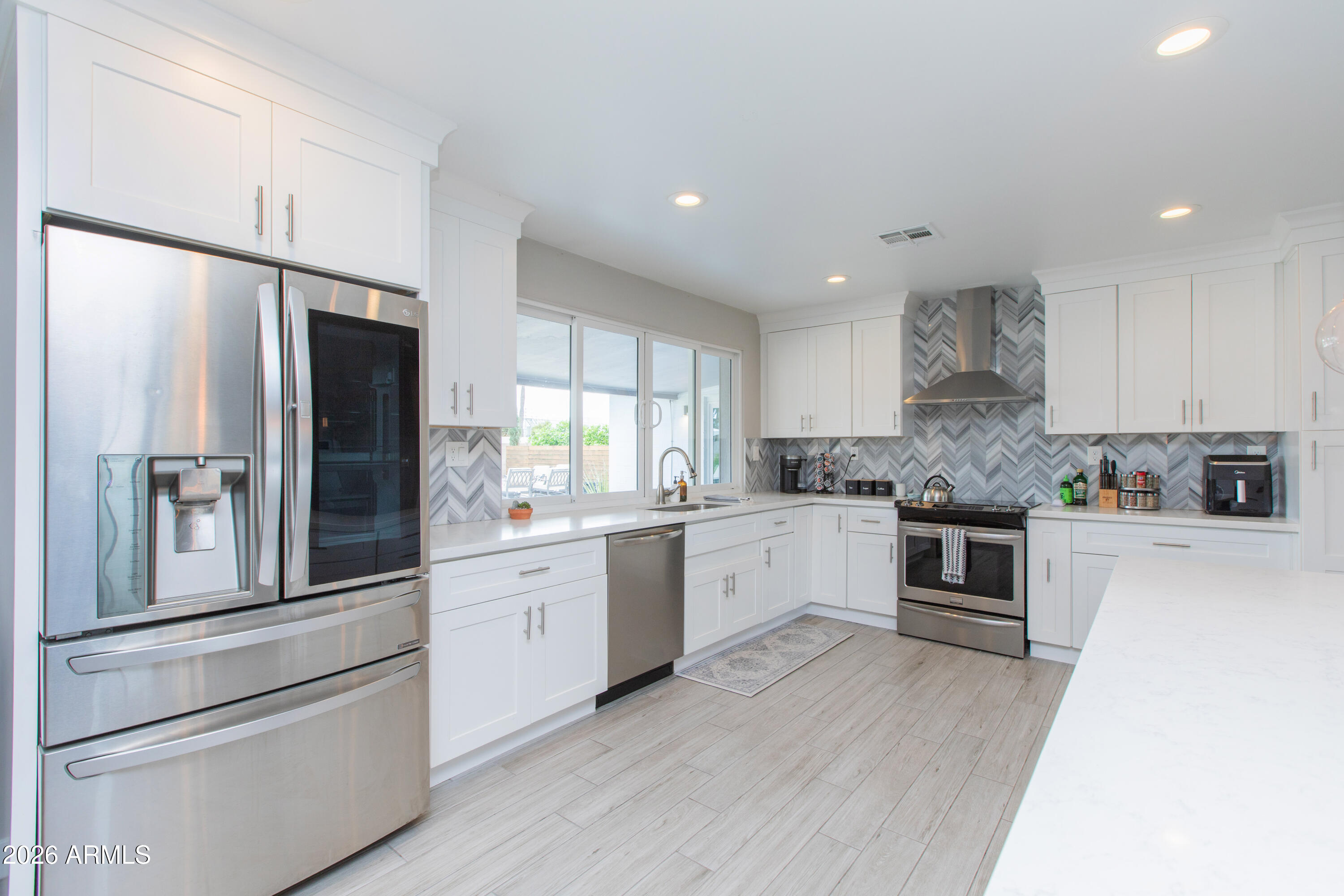 5541 East Cheery Lynn Road Phoenix, AZ 85018 - Photo 23 of 69 a kitchen with granite countertop white cabinets and stainless steel appliances
