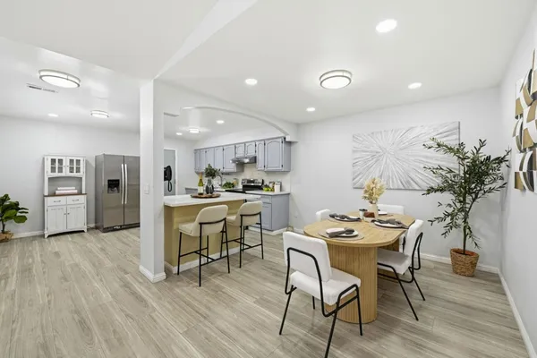 a view of a dining room with furniture and wooden floor