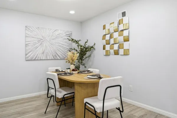 a dining room with furniture and wooden floor
