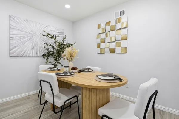 a view of a dining room with furniture and wooden floor