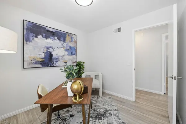 a dining room with furniture and wooden floor
