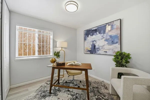 a view of a workspace with furniture and a potted plant