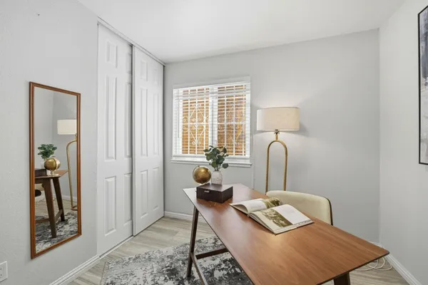 a living room with furniture and wooden floor