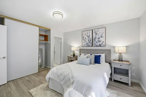 a bedroom with a bed and a night stand