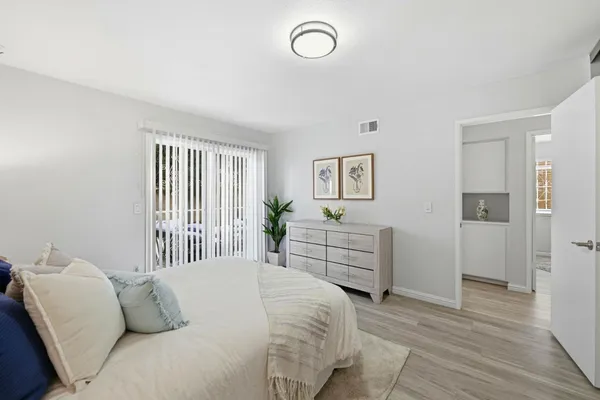 a bedroom with a bed and wooden floor