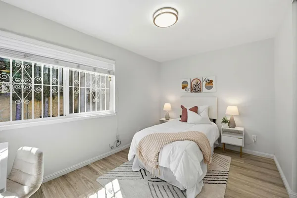 a bedroom with a bed and a window