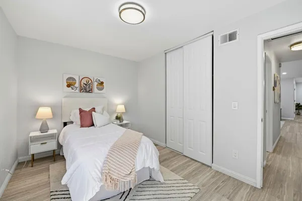 a bedroom with a bed and a lamp