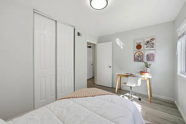 a bedroom with a bed and a chair in it