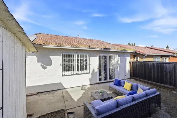 a view of a patio with couches chairs with wooden floor