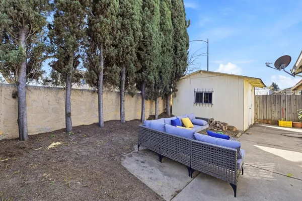 a backyard of a house with table and chairs