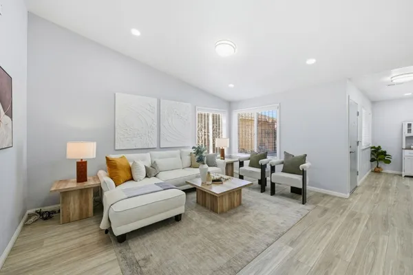 a living room with furniture and wooden floor