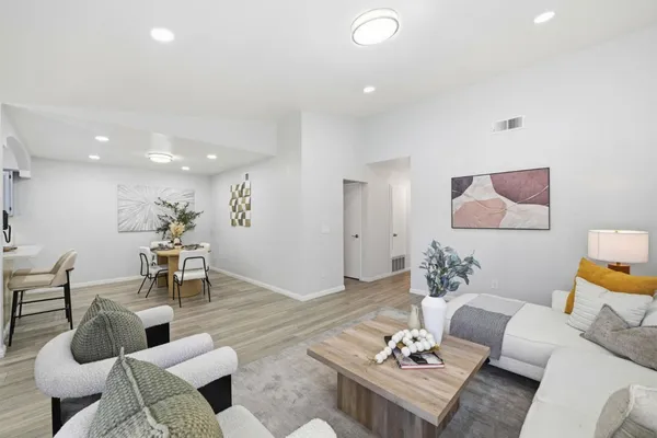 a living room with furniture and wooden floor