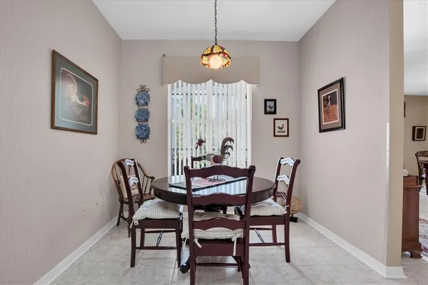 a dining room with furniture and window