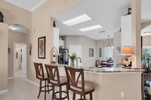 a view of a dining room with furniture and a chandelier