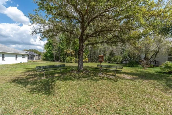 an aerial view of a house with a yard and lake view