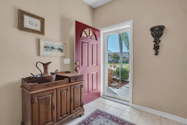 a view of a hallway to a livingroom with furniture