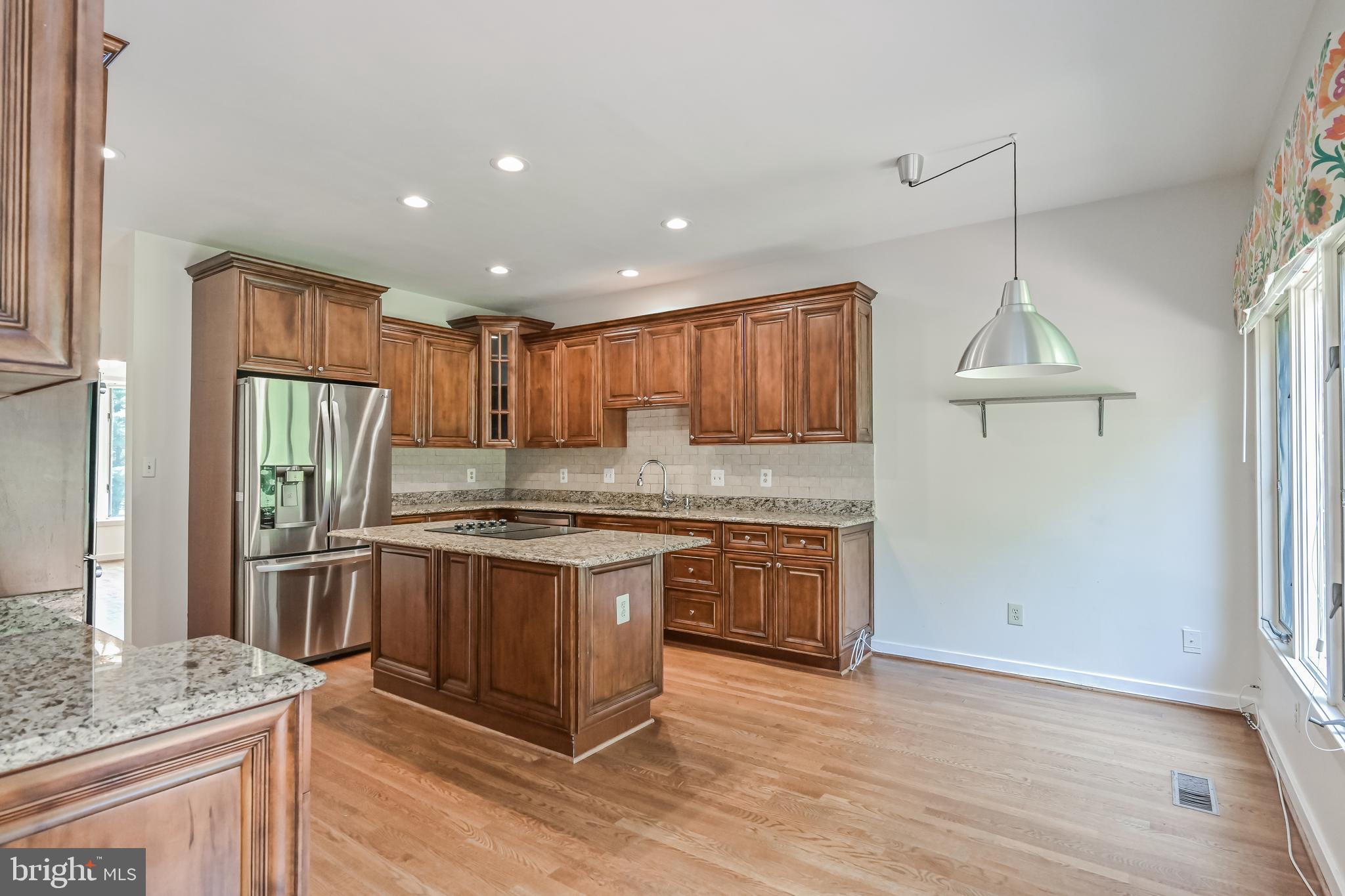445 Springvale Road Great Falls, VA 22066 - Photo 13 of 62 a kitchen with stainless steel appliances granite countertop a sink a stove a refrigerator and cabinets