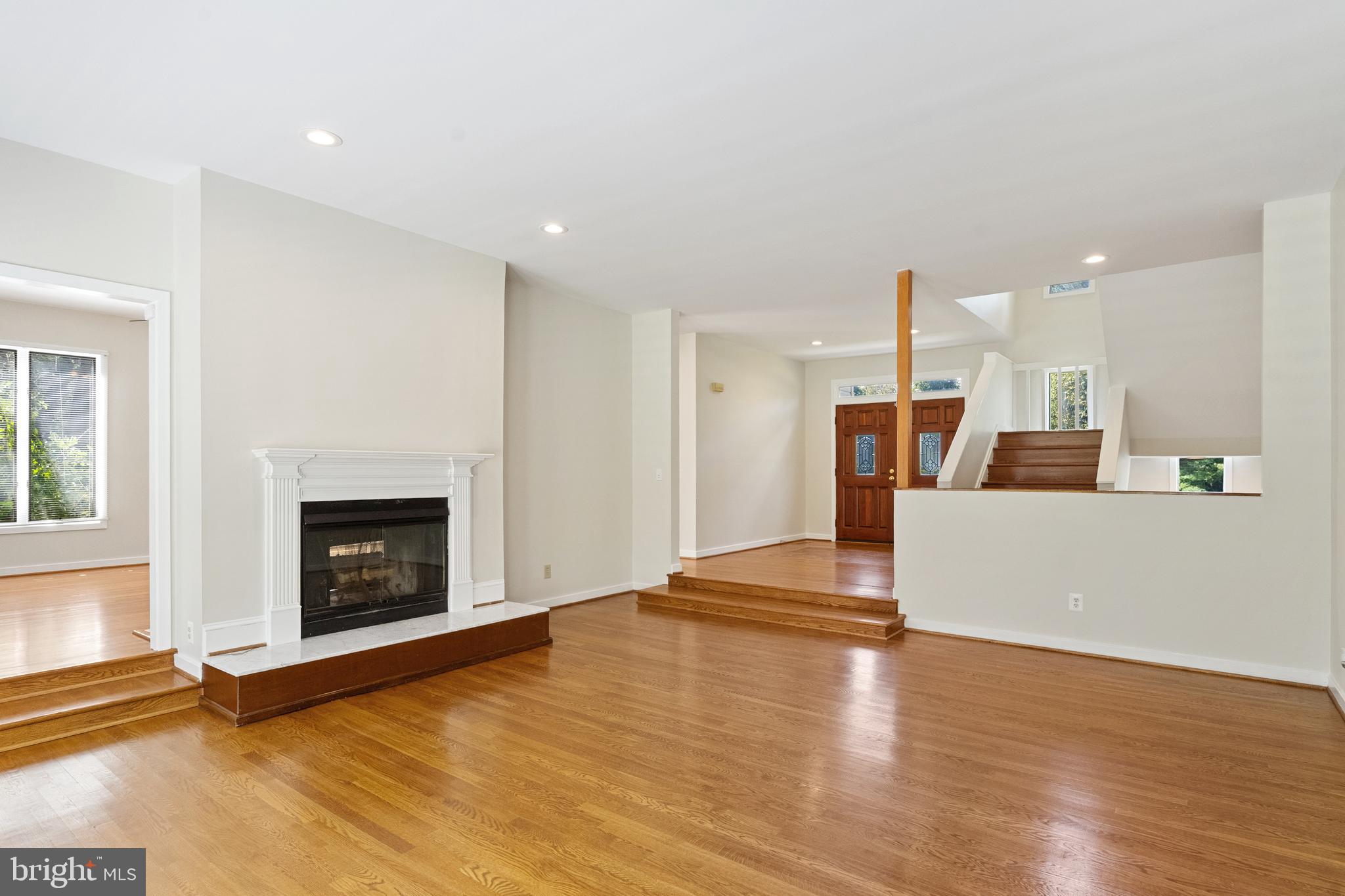445 Springvale Road Great Falls, VA 22066 - Photo 17 of 62 a view of empty room with wooden floor and fireplace