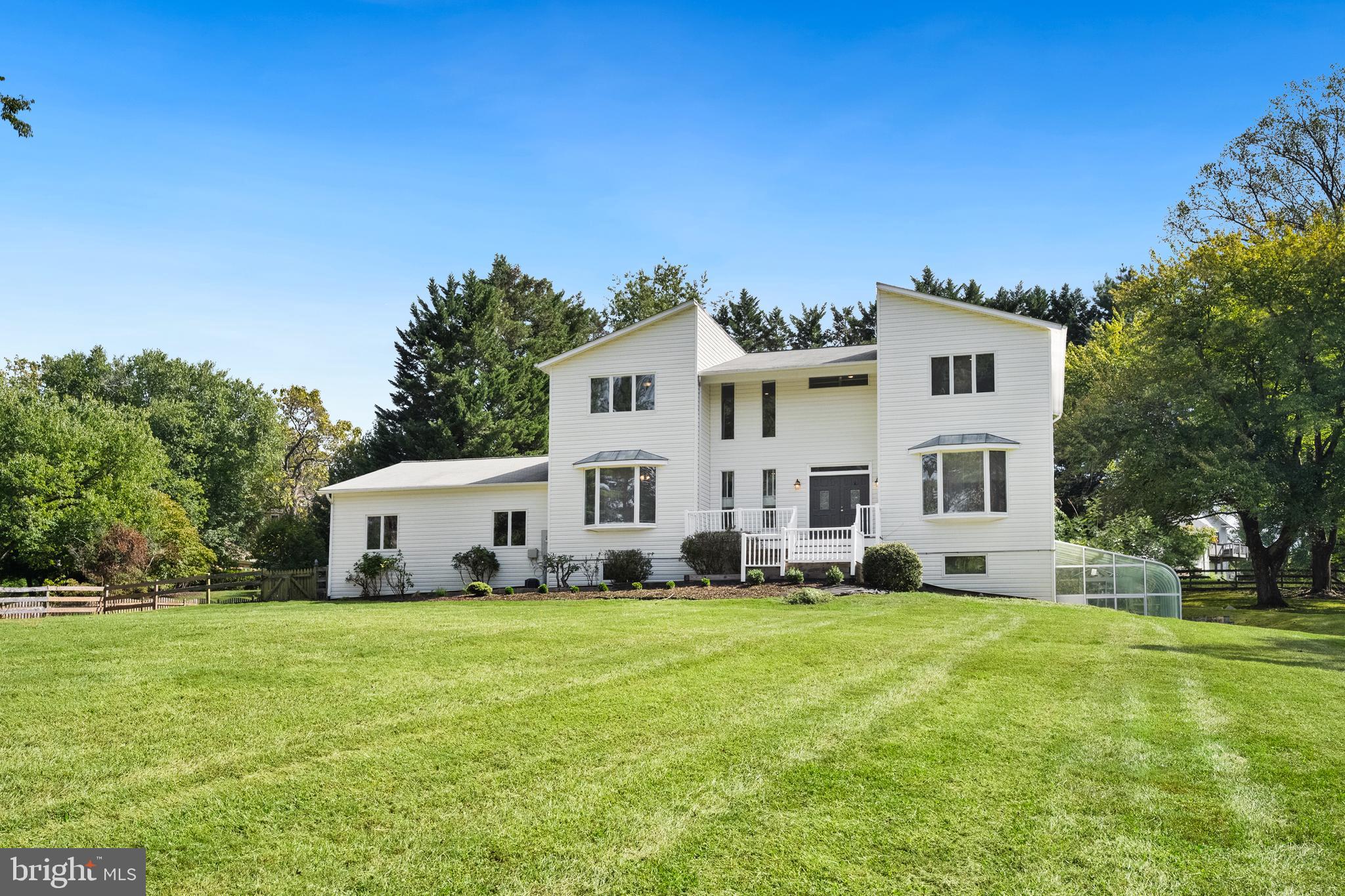 445 Springvale Road Great Falls, VA 22066 - Photo 2 of 62 a white house with a big yard and more windows