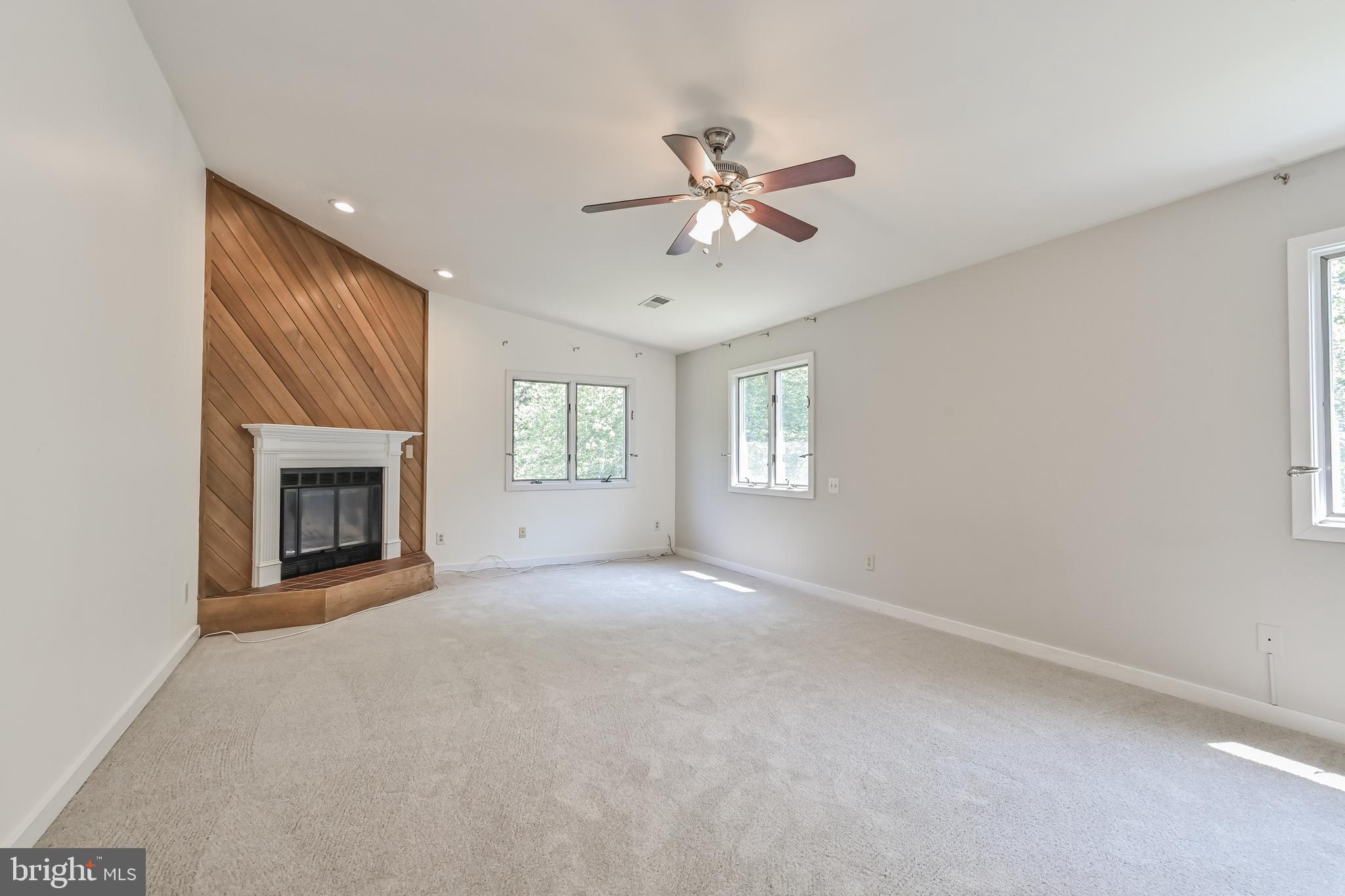 445 Springvale Road Great Falls, VA 22066 - Photo 24 of 62 a view of empty room with windows and fireplace