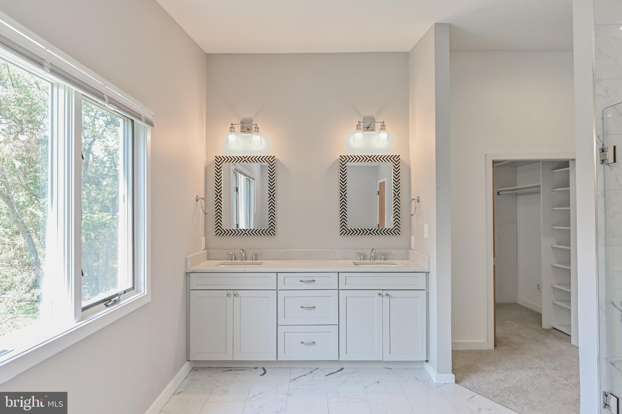 445 Springvale Road Great Falls, VA 22066 - Photo 28 of 62 a spacious bathroom with double vanity a mirror a bathtub and a shower