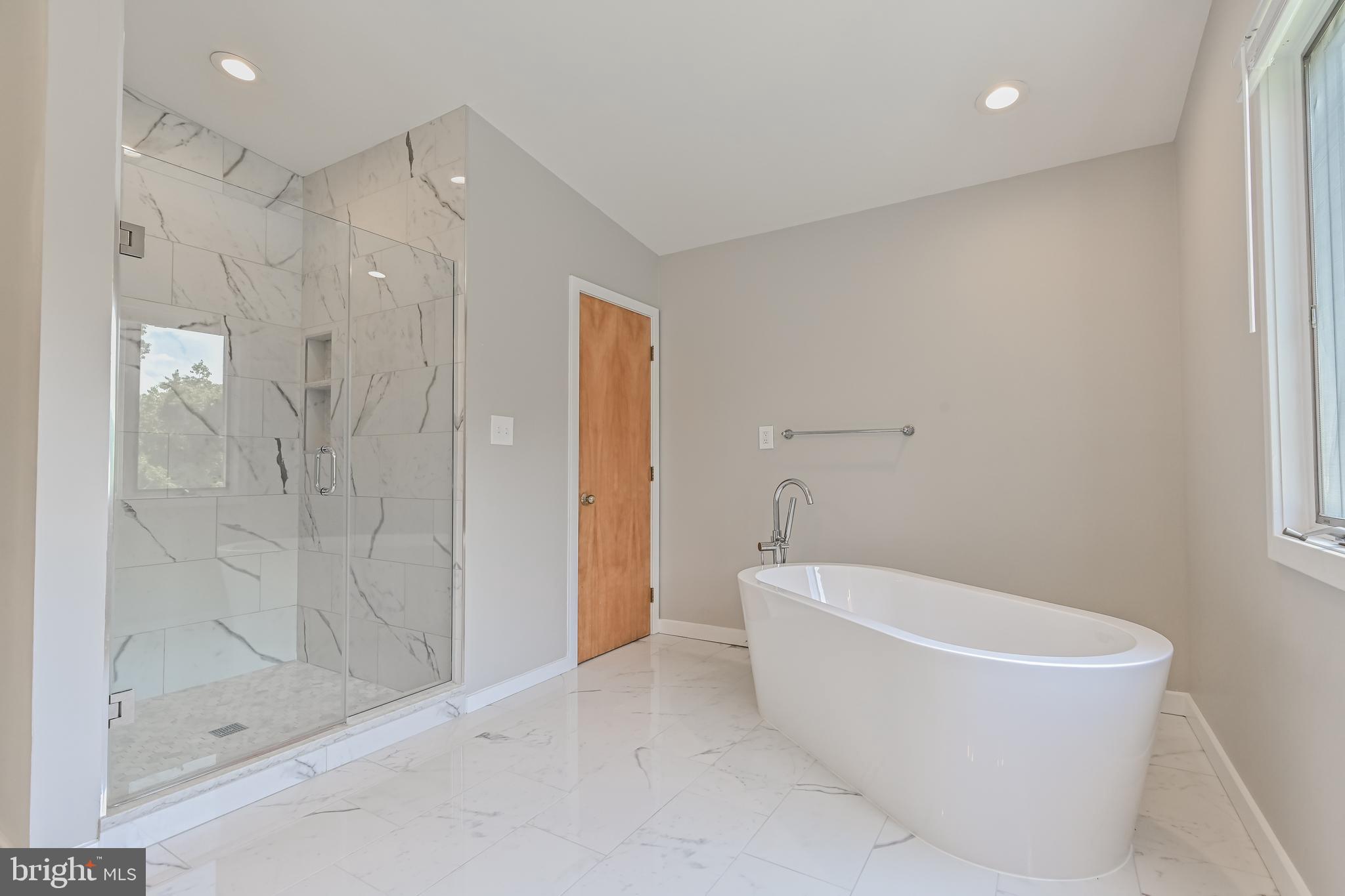 445 Springvale Road Great Falls, VA 22066 - Photo 30 of 62 a bathroom with a bathtub and shower