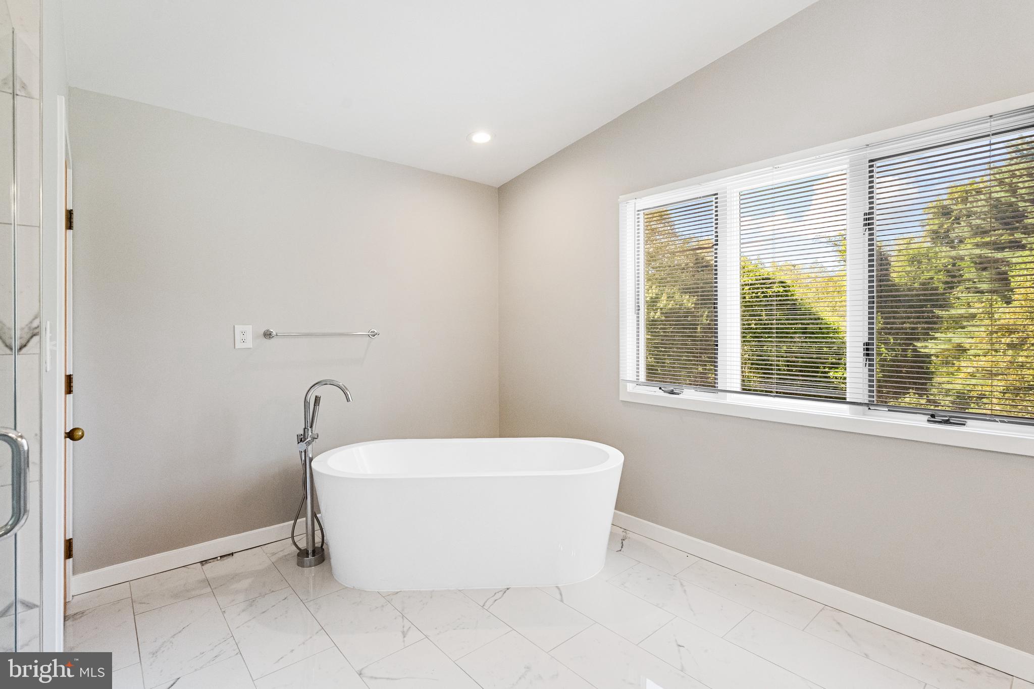 445 Springvale Road Great Falls, VA 22066 - Photo 31 of 62 a bathroom with a bathtub and window