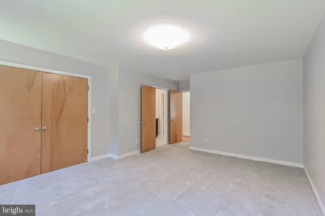 a view of a livingroom with wooden floor and a fireplace