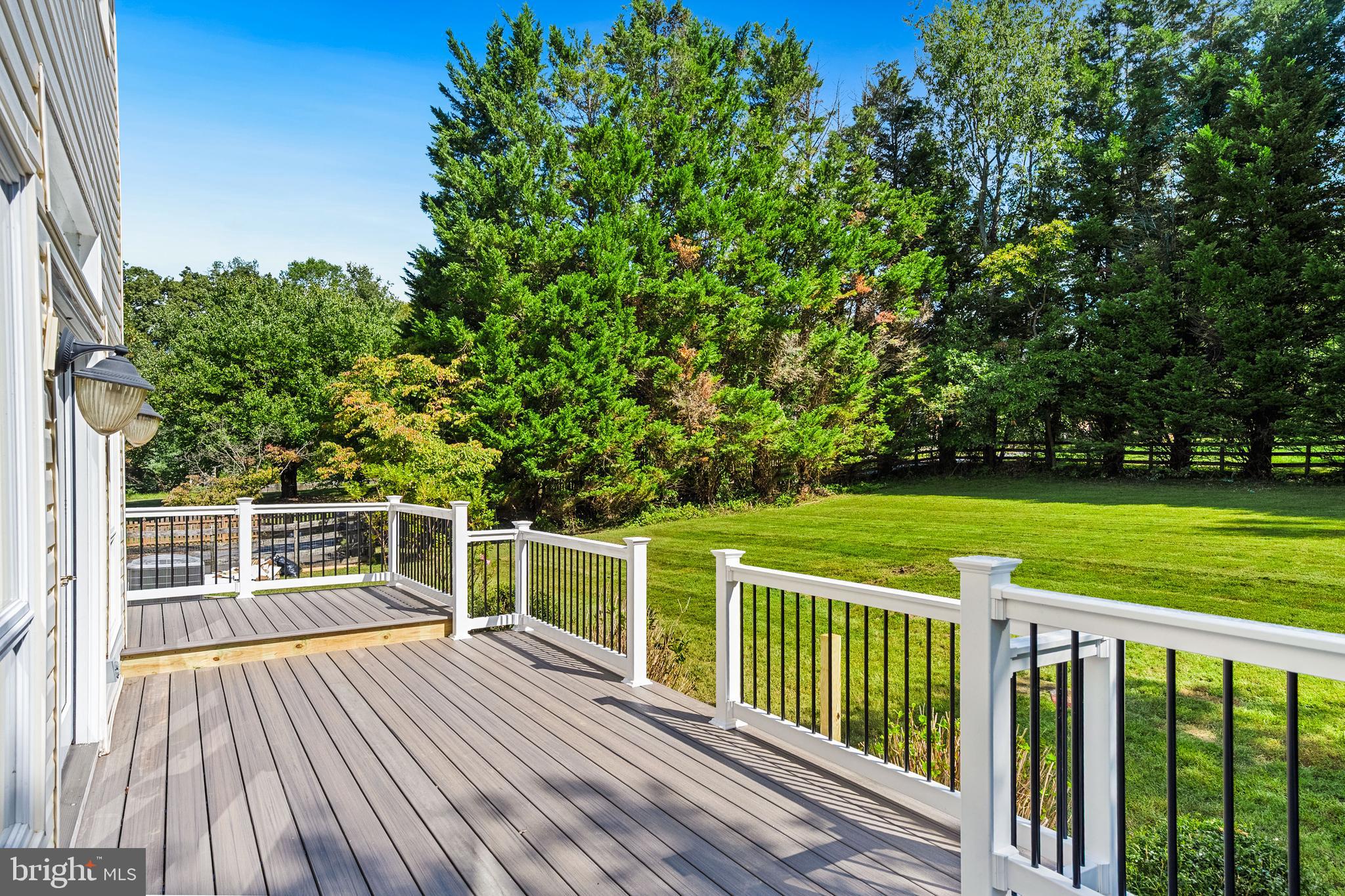 445 Springvale Road Great Falls, VA 22066 - Photo 52 of 62 a view of a wooden deck with a big yard