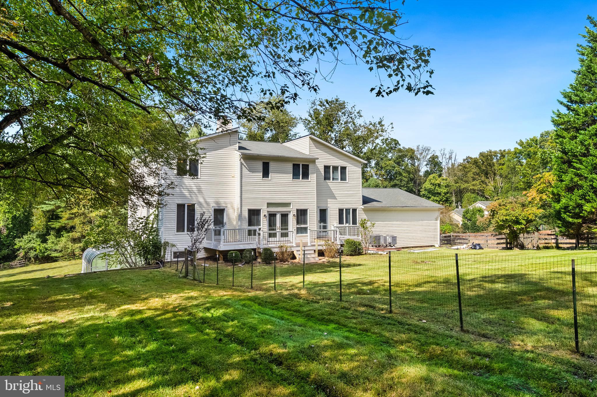 445 Springvale Road Great Falls, VA 22066 - Photo 58 of 62 a front view of a house with a yard