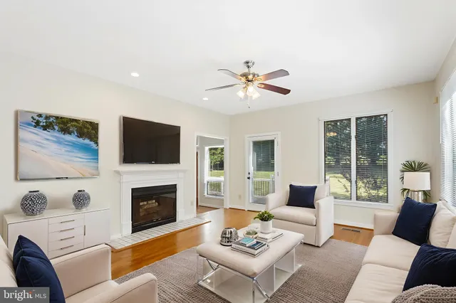 a view of empty room with wooden floor and fireplace