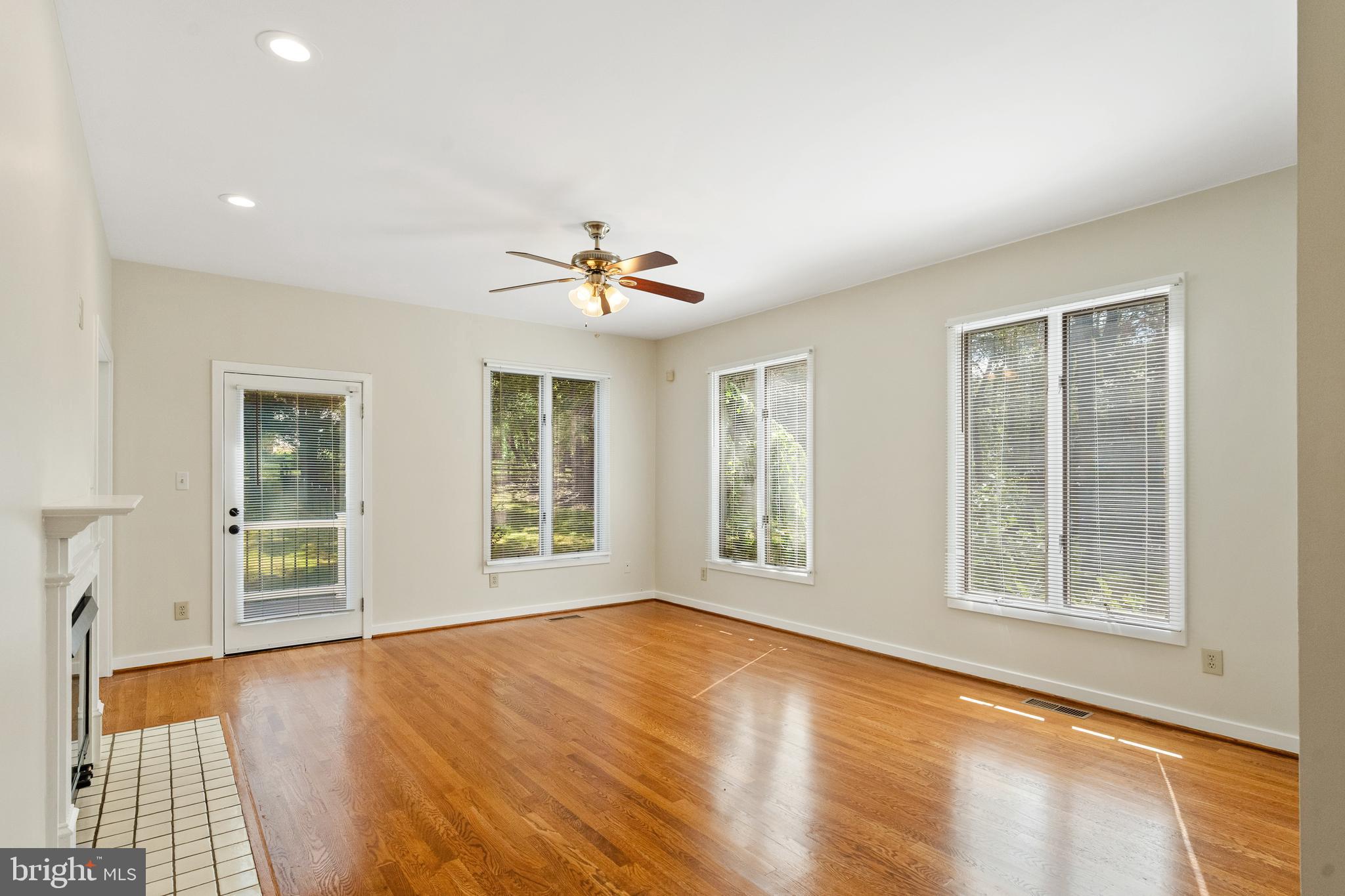 445 Springvale Road Great Falls, VA 22066 - Photo 8 of 62 a view of an empty room with a window and wooden floor