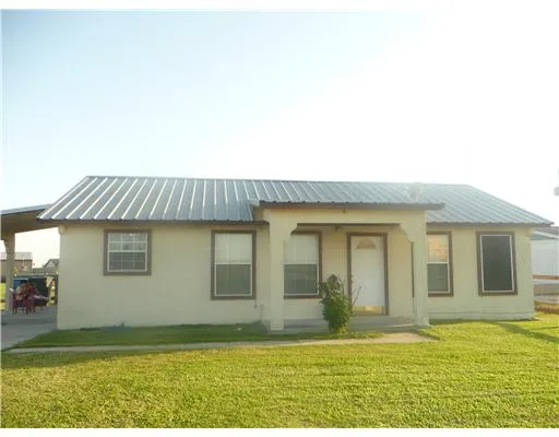 a view of an house with backyard space and balcony