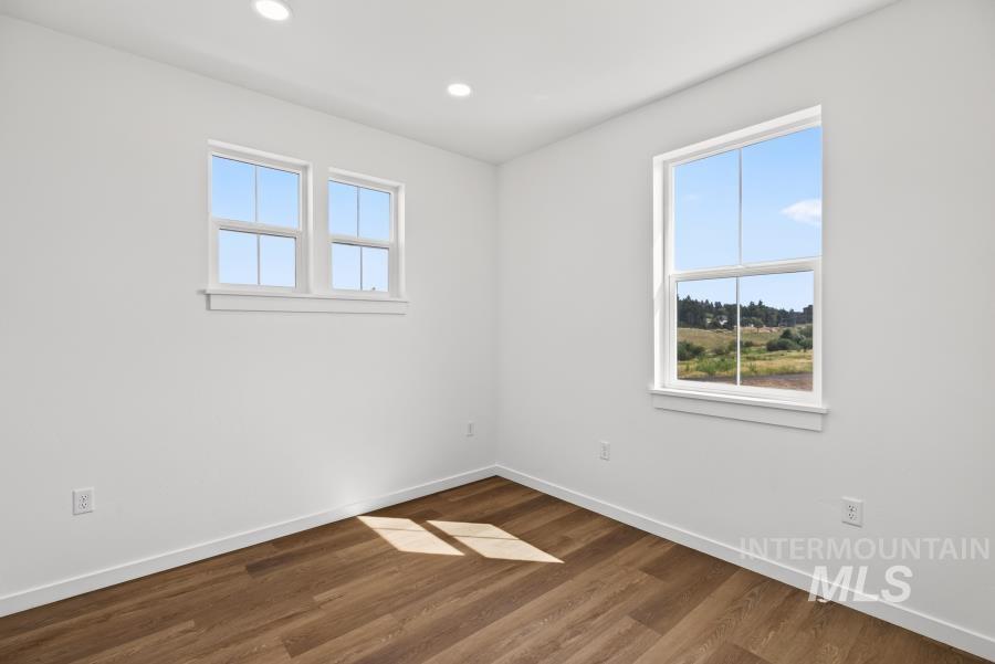 1298 Edington Moscow, ID 83843 - Photo 13 of 32 Recessed lighting, wood-finish flooring, and white walls with multiple windows