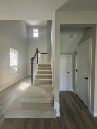 a view of entryway and hall with wooden floor