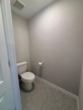 a bathroom with a toilet and a vanity