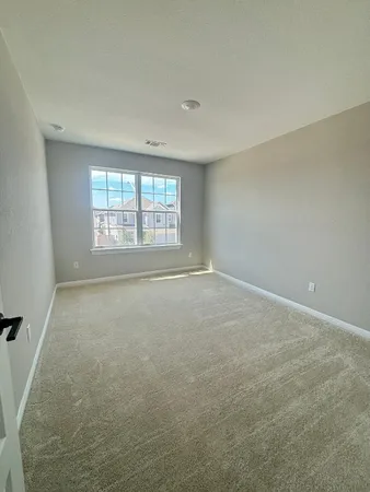 an empty room with a empty space and windows