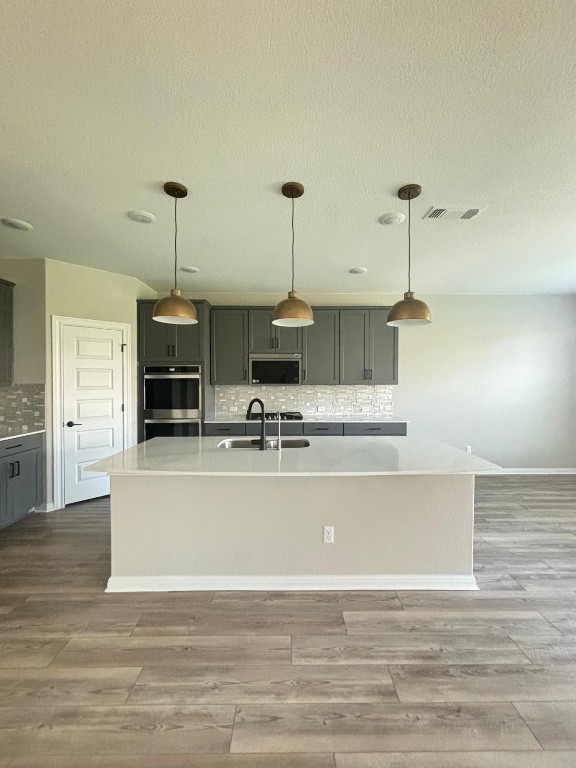305 Harbors Lane Leander, TX 78641 - Photo 7 of 28 a view of kitchen and hall with wooden floor