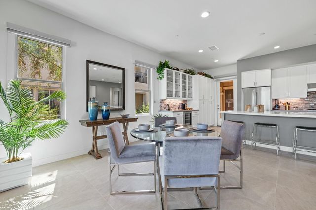 a large kitchen with stainless steel appliances lots of counter space and wooden floor