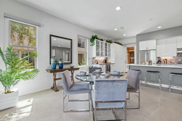 a large kitchen with stainless steel appliances lots of counter space and wooden floor