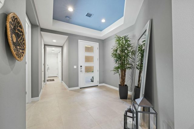 a view of a livingroom with furniture and a potted plant