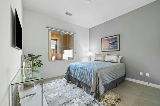 a living room with patio furniture and a floor to ceiling window