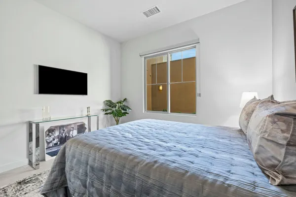 a view of a livingroom with furniture and floor to ceiling window