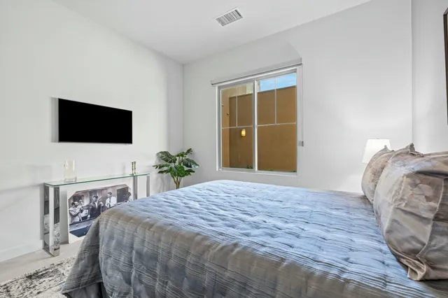 a view of a livingroom with furniture and floor to ceiling window