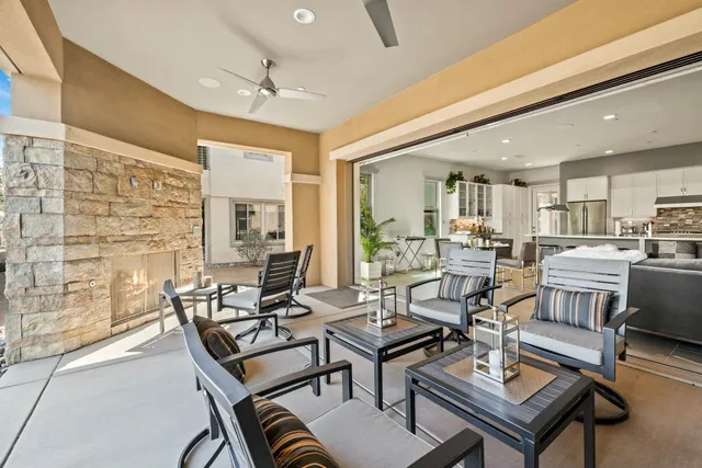 a view of a house with swimming pool and sitting area