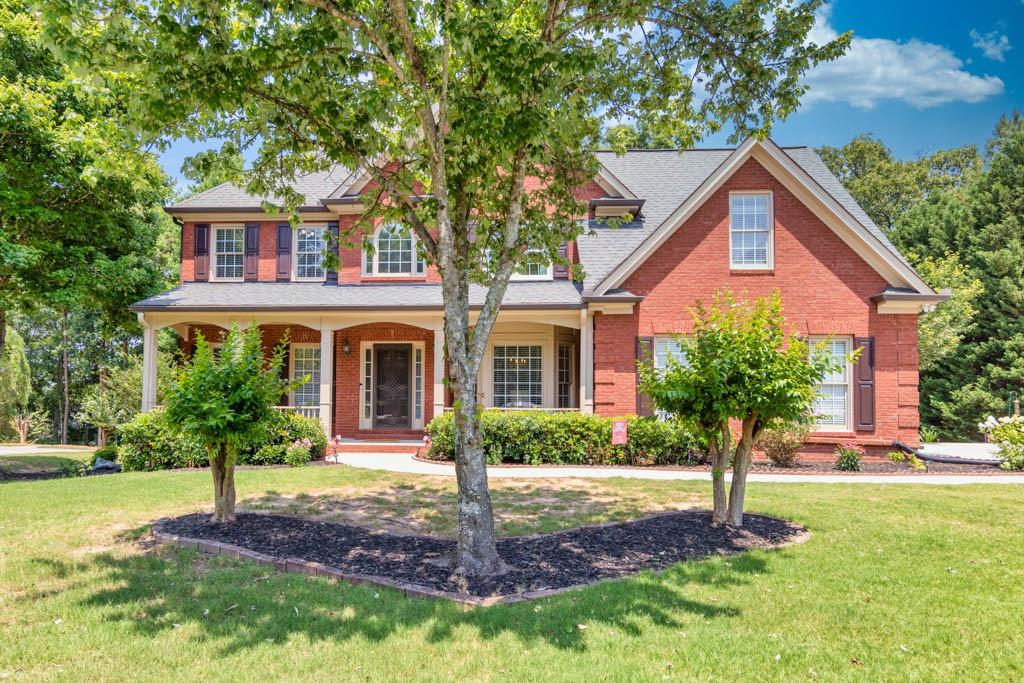 224 Brackin Trace Grayson, GA 30017 - Photo 1 of 1 a front view of a house with a yard