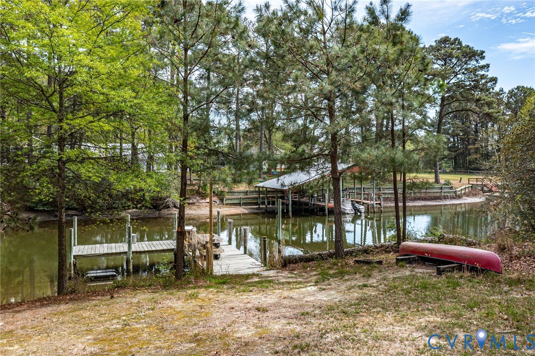 193 Deep Water Lane Reedville, VA 22539 - Photo 59 of 84 a view of a bench in the patio next to a yard